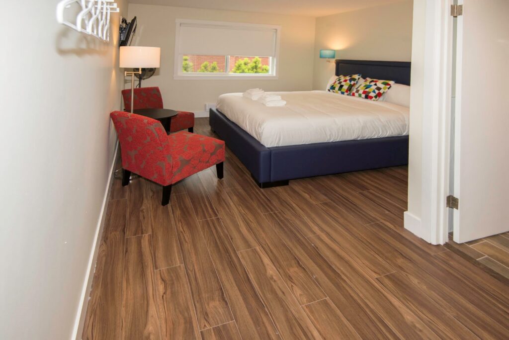 Inside Angle of King Bed 2 red chairs